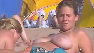 Voyeur films amazing blonde girl with big boobs on the public beach on SpyAmateur.com